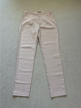 WOMAN pale pink satin trousers.